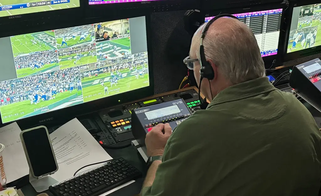 Production Crew Member Sitting at Console